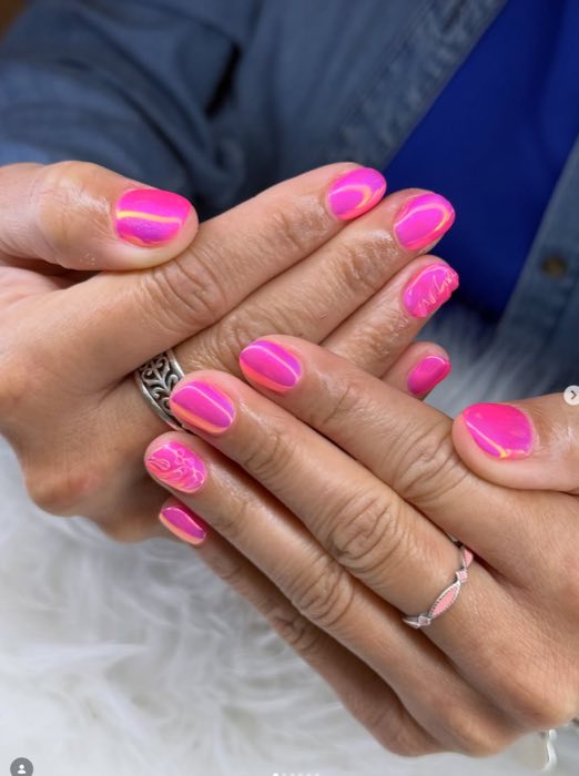 Glossy white and pink nails with layered rings